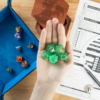 green and gold wedding dice on a hand
